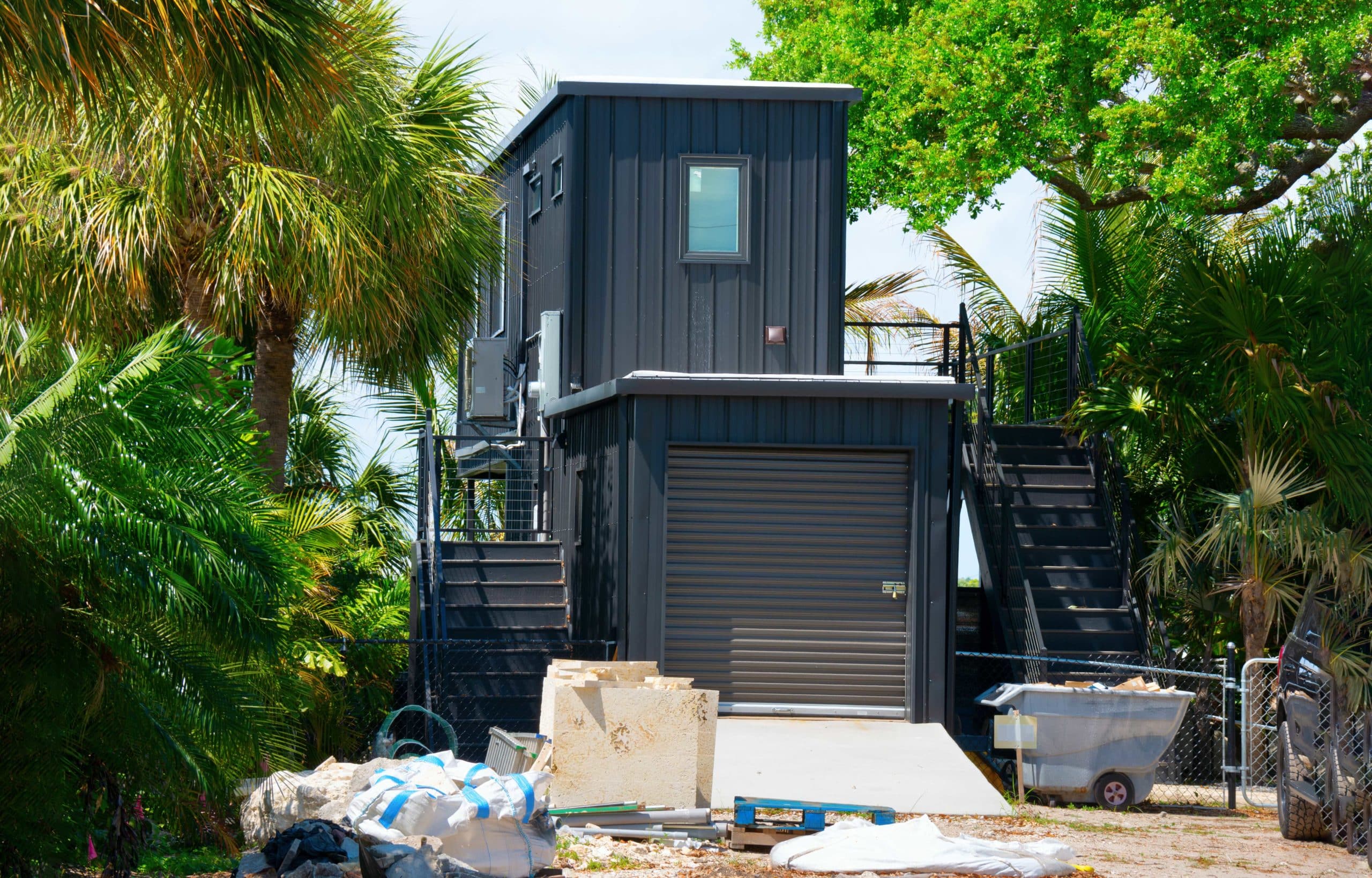 shipping container garage with living area above.