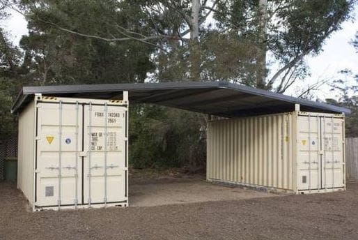 shipping container garage with roof in-between two containers.