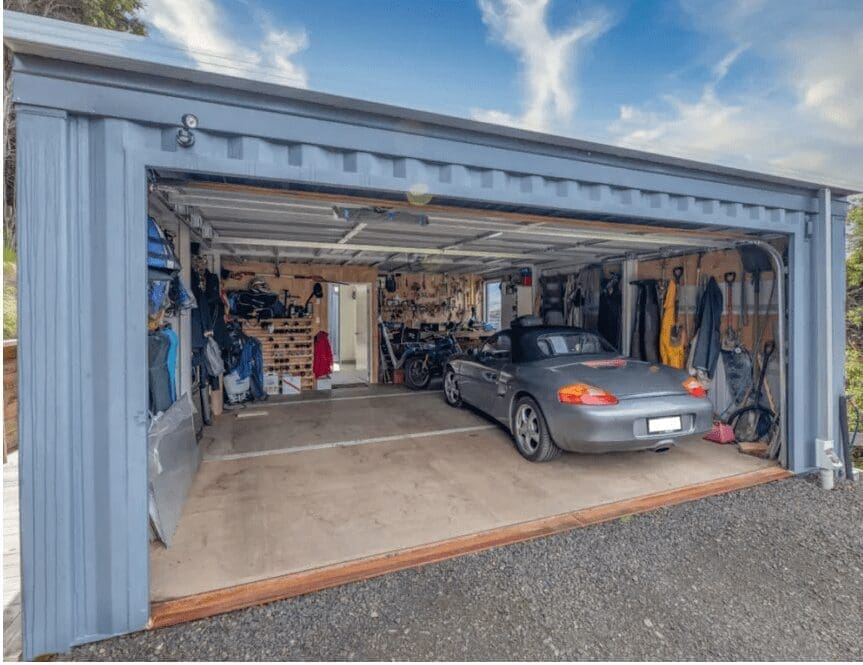 Neatly organized shipping container garage made from 20 ft new shipping containers