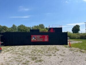 Angola Fire Training Facility – modern fire training building with used 40 ft shipping containers painted black.