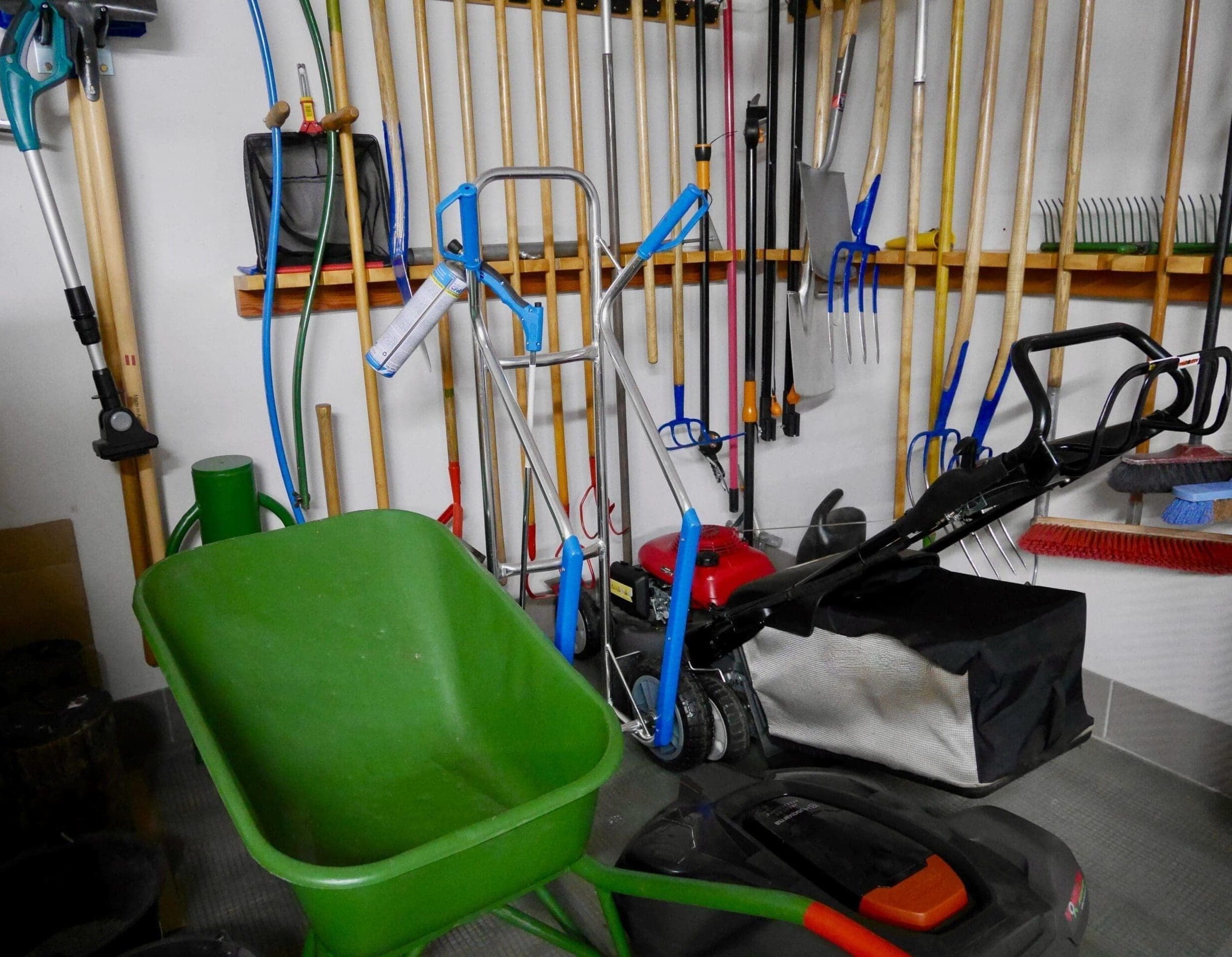 A finished shipping container garage interior with tools and a workbench along one wall