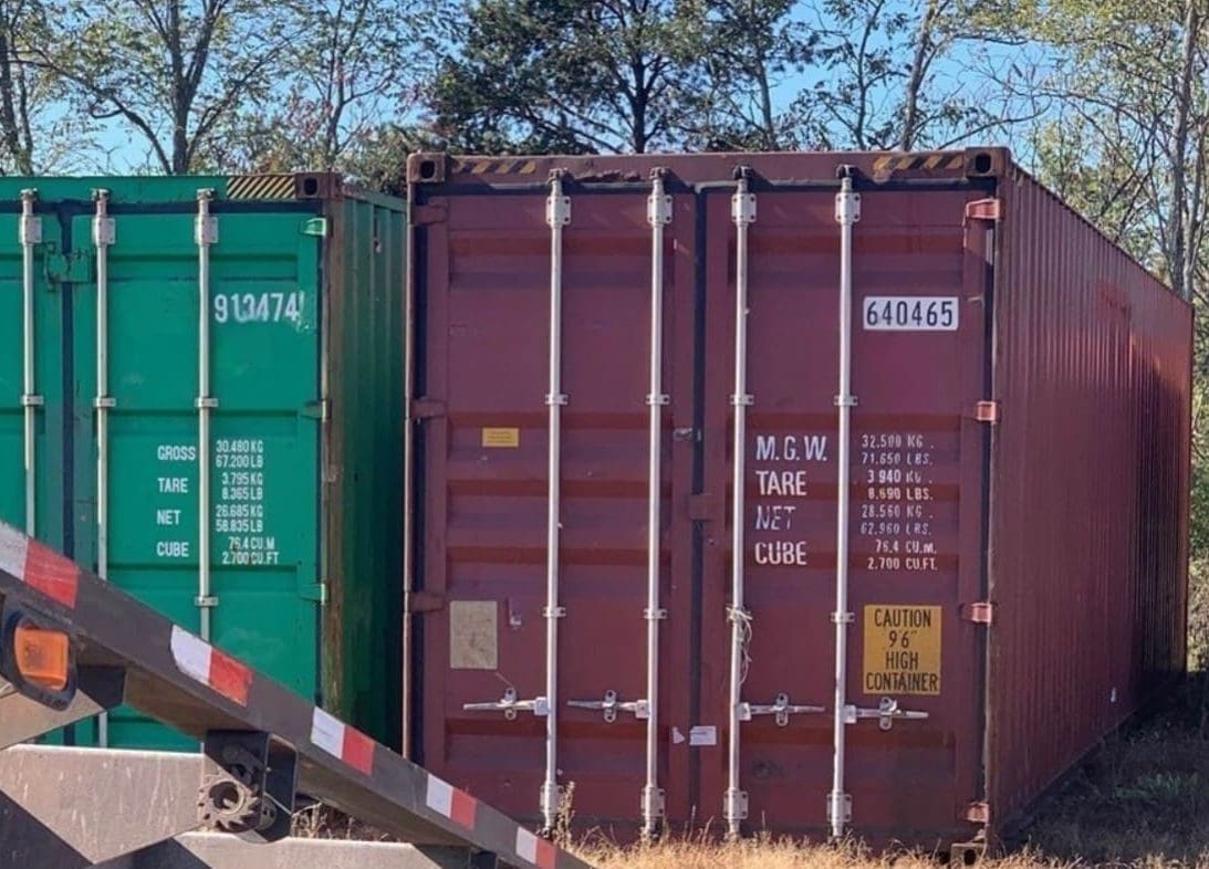 Standard height vs high cube shipping container side by side showing 1-foot height difference